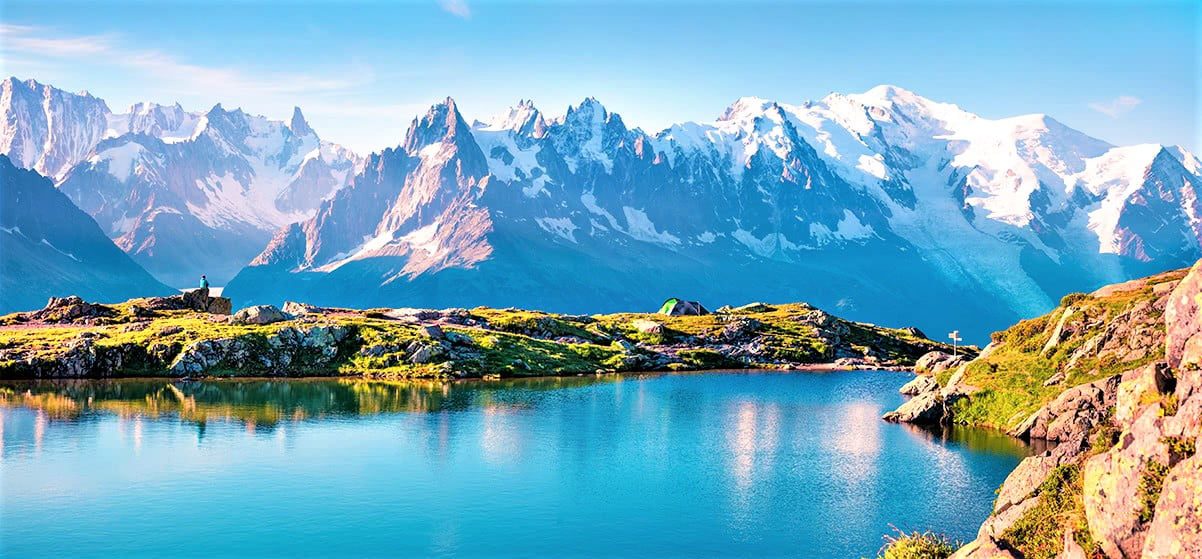 A beautiful scene at France with snowy mountains and lake