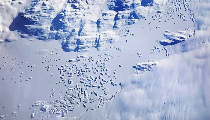 A glacier along the east coast of Greenland is seen out the window of a Gulfstream jet