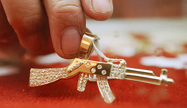 he AK-47 has become a symbol as well as a weapon, as evidenced by this diamond-encrusted pendant once owned by an alleged drug fugitive from Mexico