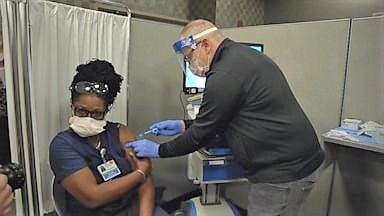 Health care workers given COVID-19 vaccine after months of tirelessly fighting virus